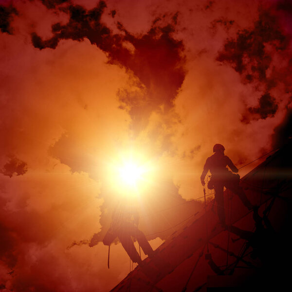 industrial climber on the ropes, silhouette.