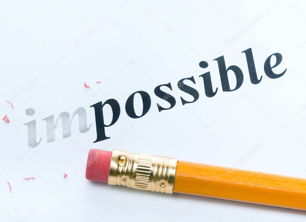 Word ' impossible ' and pencil with eraser close-up