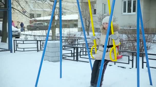 Little girl swinging on a swing slow motion — Stock Video