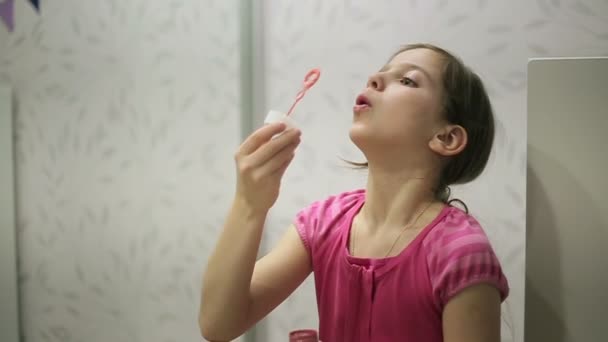 Little girl blows soap bubbles slow motion — Stock Video