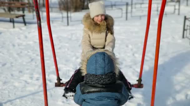 Children swinging on a swing — Stock Video