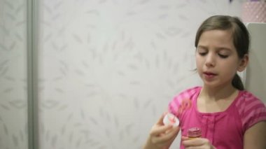 Little girl blows soap bubbles