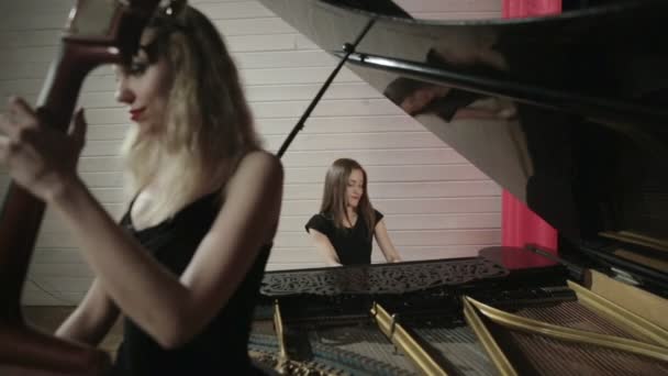 Two young women playing a musical instruments — Stock Video