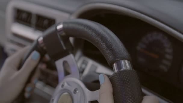 Closeup hands of female driver at the steering wheel — Stock Video