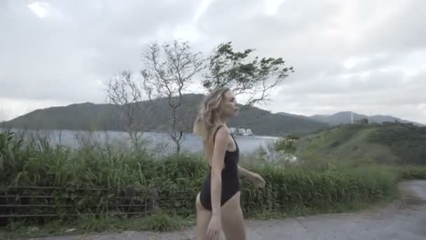 Bella donna che cammina in costumi da bagno neri — Video Stock
