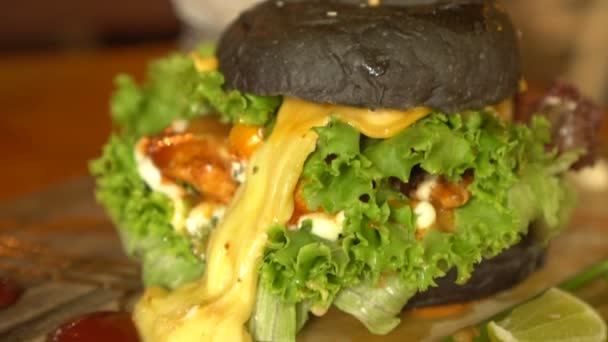 Closeup of home made black burger — Stock Video