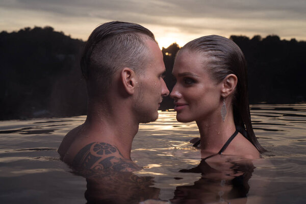 Romantic couple alone in infinity swimming pool