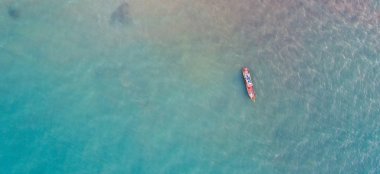 Aerial view of moored fishing boat in the sea waters of Phuket clipart