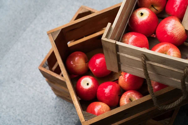 Wooden crate box full of fresh red apples