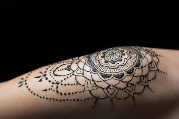 Closeup henna tattoo on woman\'s shoulder