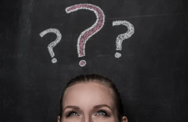 Confused woman and question marks — Stock Photo, Image