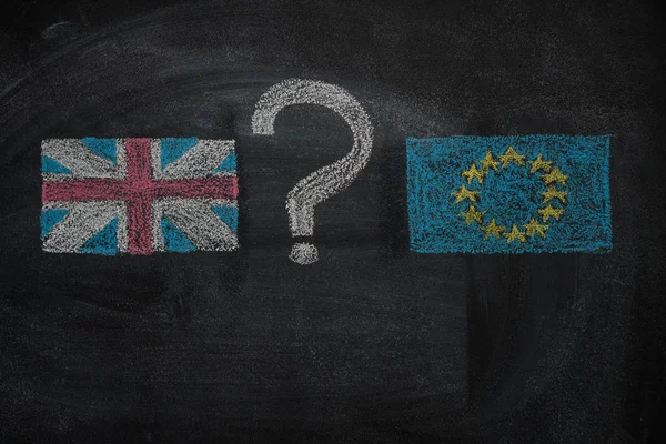Brexit, flags of the United Kingdom and the European Union with question mark between  on blackboard