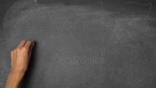 Hand writing "FUN" on black chalkboard — Stock Video