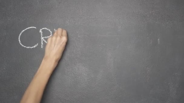 Hand writing "CRYPTOCURRENCY" on black chalkboard — Stock Video