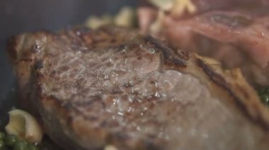 Taze yeşil biber, kızarmış tereyağı ve Pan - ağır çekimde video ısıtmalı sıcak ızgara lezzetli sığır eti biftek closeup yerleştirilen