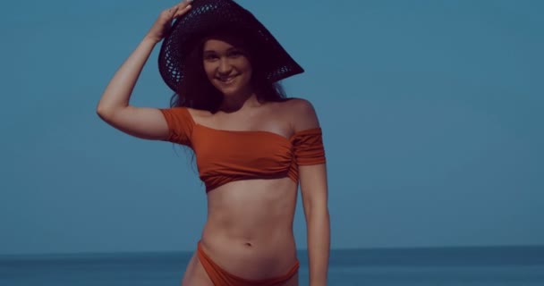 美少女 美しい熱帯のビーチでビキニや熱帯ビーチ スローモーションでビデオの夏の休暇中に太陽の下でリラックスした帽子の女の子 — ストック動画