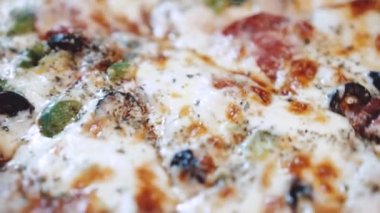 Restoranda yeni pişmiş süper pizzanın makro yakın çekimi. Yavaş çekimde video.