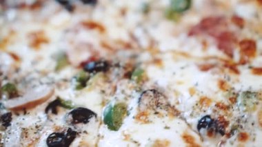Restoranda yeni pişmiş süper pizzanın makro yakın çekimi. Yavaş çekimde video.