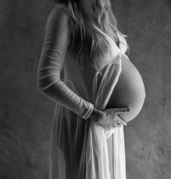 Крупный План Беременная Женщина Трогает Живот Стоя Сером Фоне Стены — стоковое фото