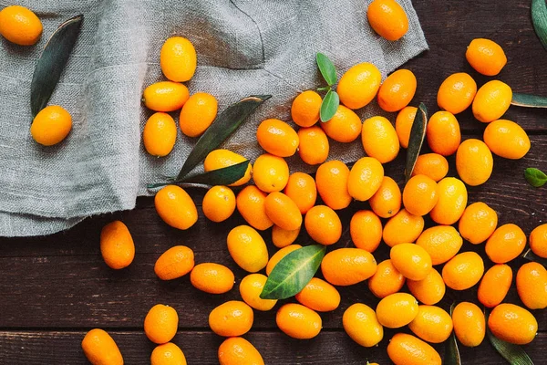 Koyu ahşap arka plan, üstten görünüm, Vintage filtresinde kumquats