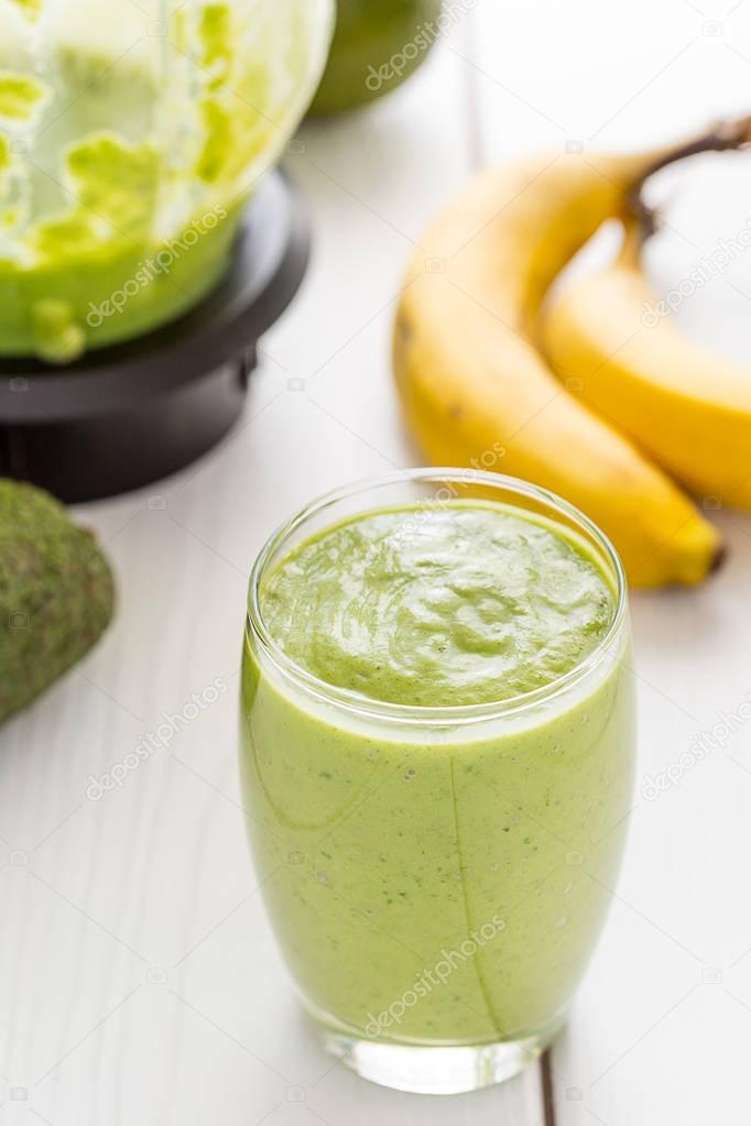 Absolutely Amazing Tasty Green Avocado Shake or Smoothie, Made with Fresh Avocados, Banana, Lemon Juice and Non Dairy Milk (Almond or Coconut) on Light White Wooden Background, Raw Food, Vegan Drink, Vegan Food Conception, Close-up