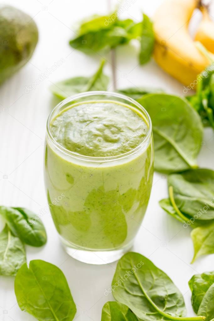 Absolutely Amazing Green Avocado Smoothie, Made with Fresh Avocados, Banana, Lemon Juice and Non Dairy Almond Milk on Light White Wooden Background, Raw, Vegan Drink Conception, Vertical View