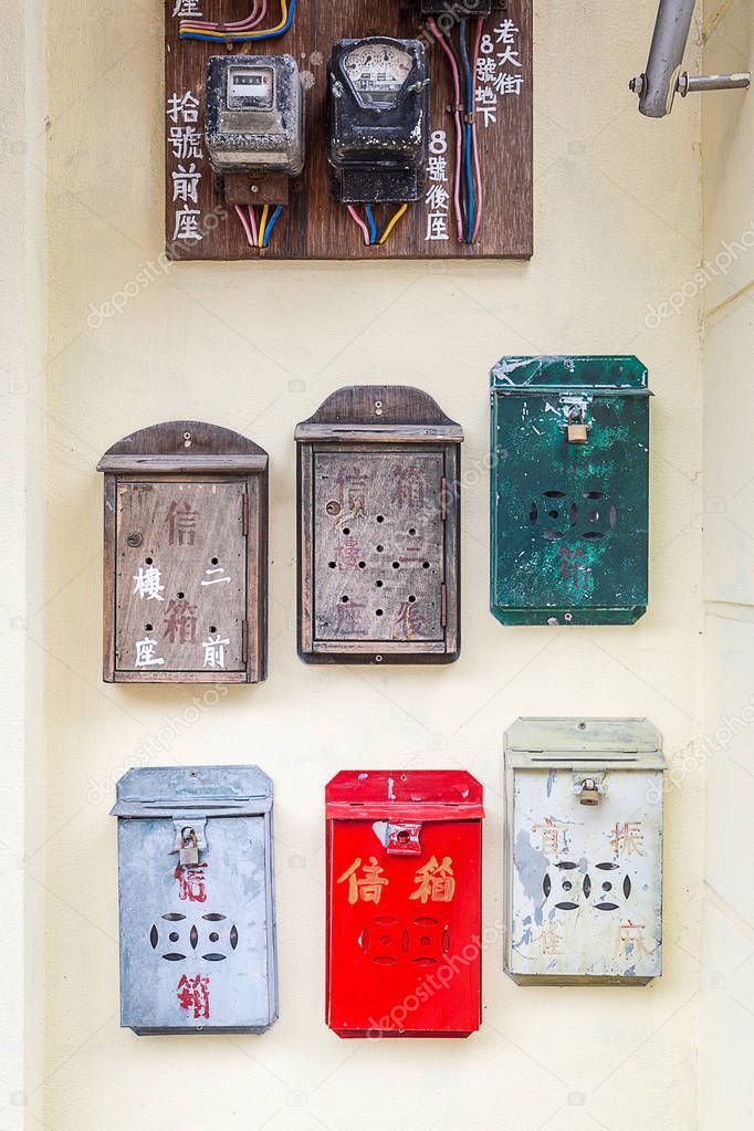 color mail boxes on old building wall