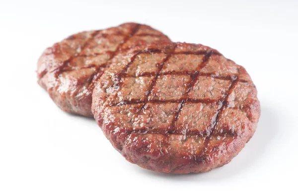 Smakelijke Gegrilde Rundvlees Hamburger Een Witte Achtergrond Voor Grafisch Ontwerp — Stockfoto