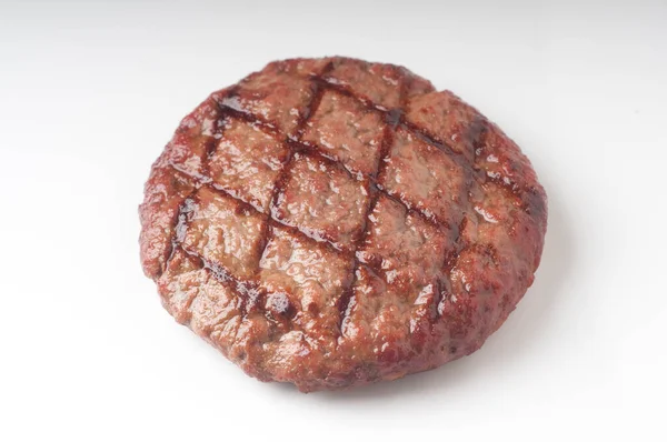 Smakelijke Gegrilde Rundvlees Hamburger Een Witte Achtergrond Voor Grafisch Ontwerp Rechtenvrije Stockafbeeldingen
