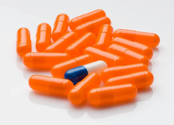 Orange Colored Pills White Background Surrounding Different Pill — Stock Photo, Image