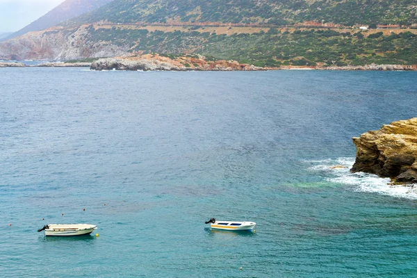 Empty motorboats drifting on waves in Bali, Crete — Stock Photo, Image