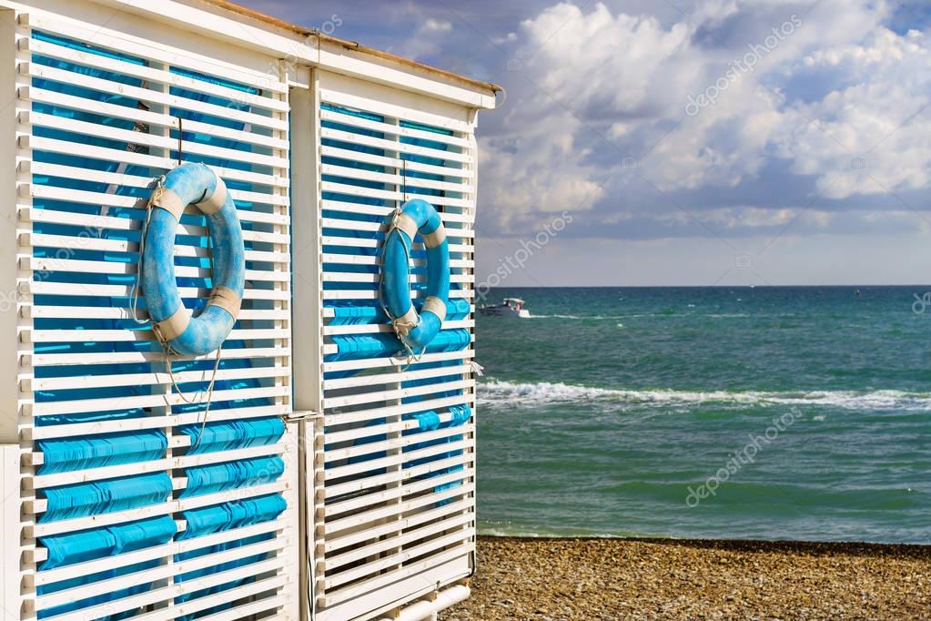 Blue lifebuoy hanging on wooden wall beach tent