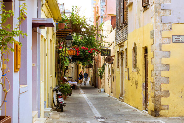 Rethymno, Greece - May 3, 2016: Walk around the old resort town Rethymno in Greece. Architecture and Mediterranean attractions on island Crete. Narrow touristic street in the tourist routes