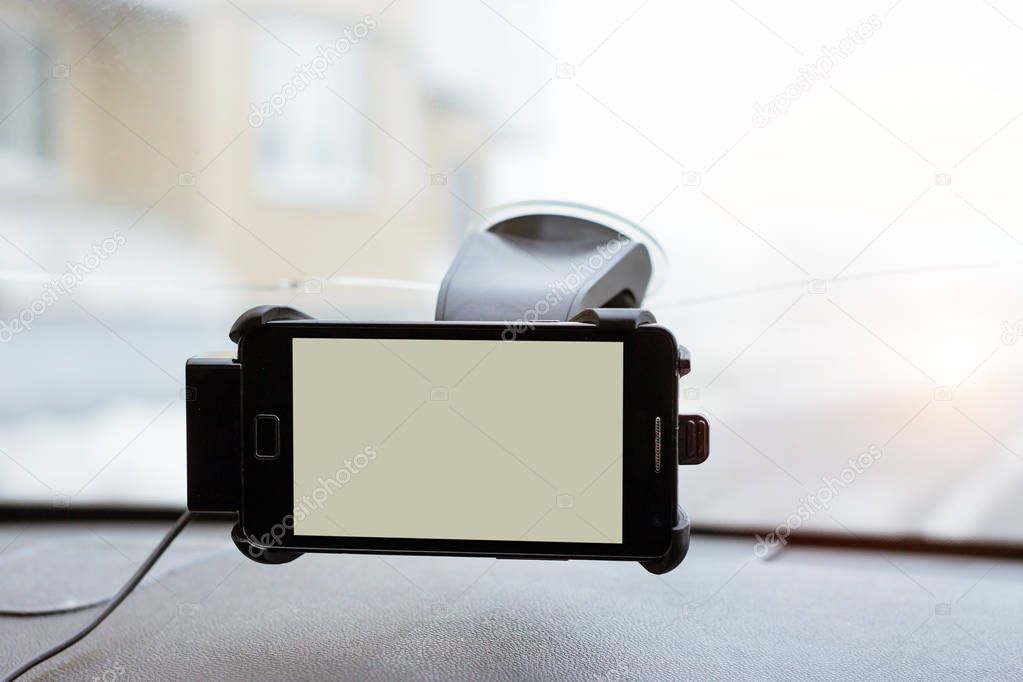 Car smartphone holder attached to windscreen auto