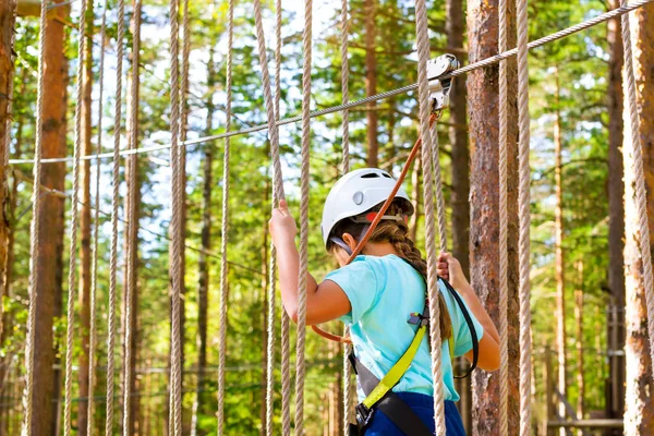 Girl on hinged trail in extreme rope Park