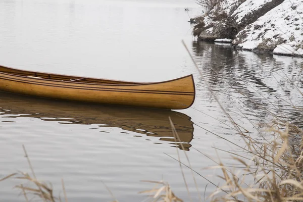 New Canoe floating on the calm water in winter sunset — Stock Photo, Image