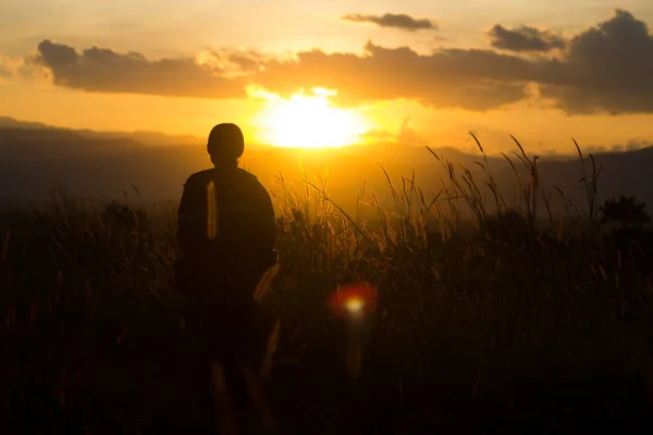 Standing on a mountain, enjoying the sunset — Stock Photo, Image