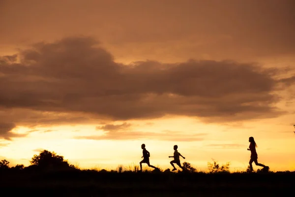 Silhouette of a Boy playing on the sunset background — Stock Photo, Image