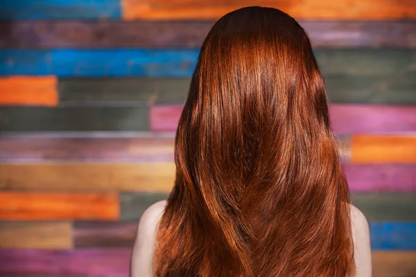 Young beautiful red-haired girl standing back to the camera — Stock Photo, Image