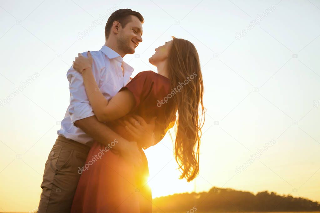 Honeymoon couple romantic in love at field sunset