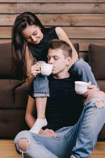 Schönes Mädchen trinkt einen Kerl mit Tee — Stockfoto