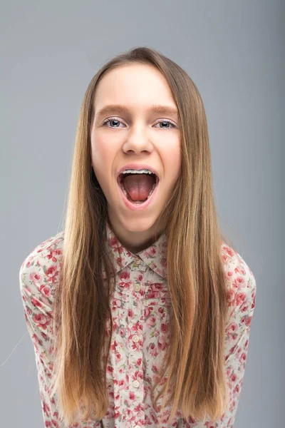 Cute blonde teen screams at camera — Stock Photo, Image