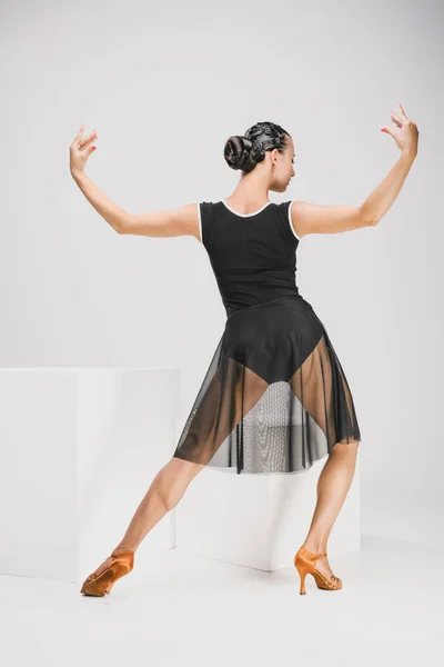 Girl in black and transparent dress turning backwards — Stock Photo, Image