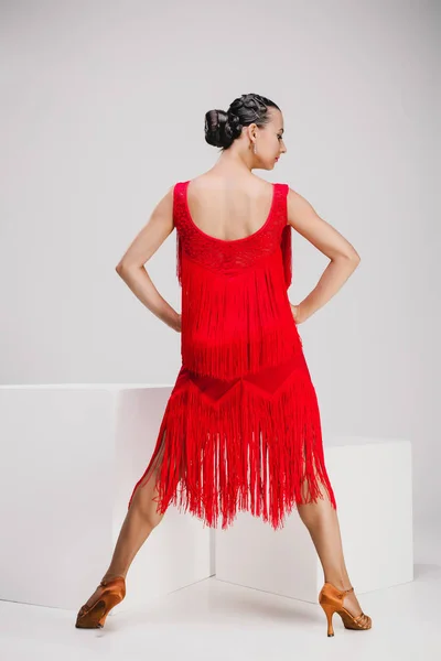 Girl in red dress turning backwards — Stock Photo, Image
