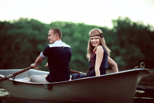 Guy and girl floating on the boat — Stock Photo, Image
