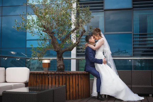 newlywed couple hugging in luxury restaurant