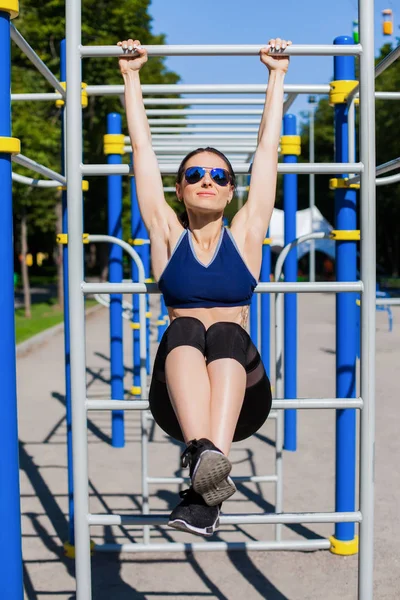 athletic woman trainer on sport playground