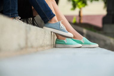 merdivenlerde oturan spor ayakkabı giyen kızlar