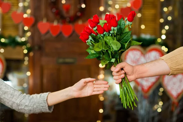 Boy present girl flowers on Valentines Day — Stock Photo, Image