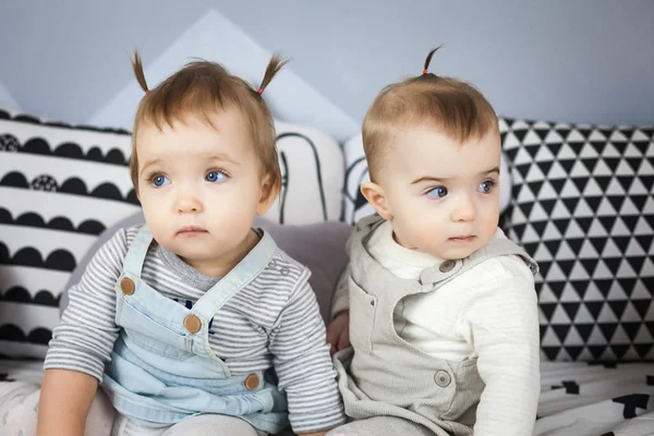 Little sisters sit on bed — Stock Photo, Image